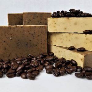 Coffee soap stacked with coffee beans.